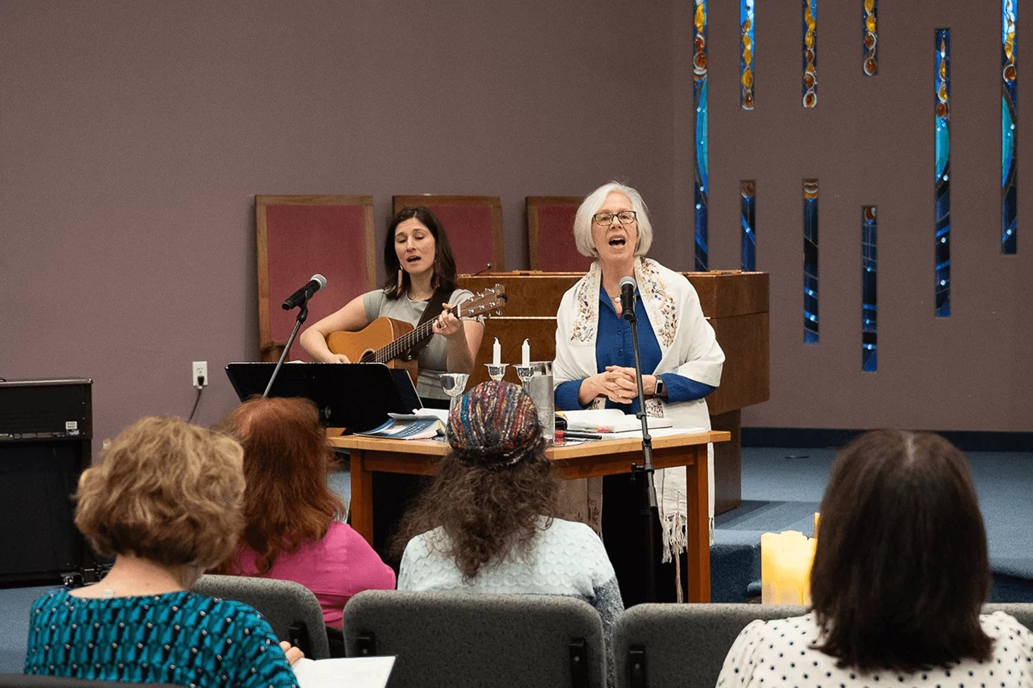 rabbi perry and ariel strasser leading shabbat service